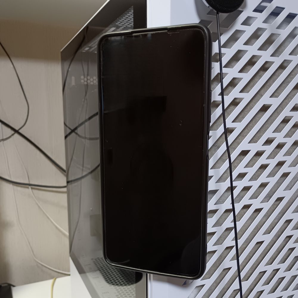 強力ネオジム磁石搭載のスマホホルダー2個を粘着部分同士で貼り合わせた物をPCケースに装着しスマホをくっつけてみました。